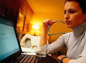 Woman sitting at laptop computer